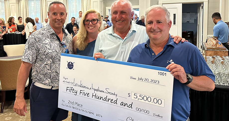 Team members proudly holding a check for $5,500 at the Chubb Charity Challenge fundraiser